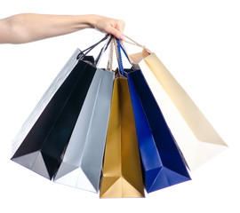 Colorful packages shopping bags in hand on white background isolation