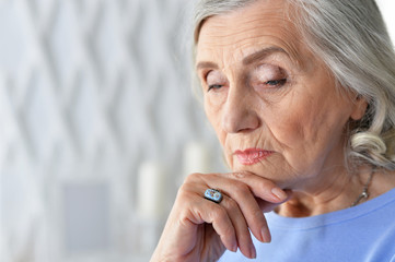 Canvas Print - Close up portrait of sad ill senior woman