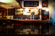 © magdal3na - Desk of free space and blurred bar interior
