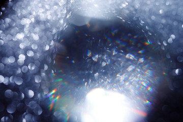 Easy to add lens flare effects for overlay designs or screen blending mode to make high-quality images. Abstract sun burst, digital flare, iridescent glare over black background. Defocused bokeh.