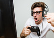 © Asier - Teenager caucasian man playing computer games