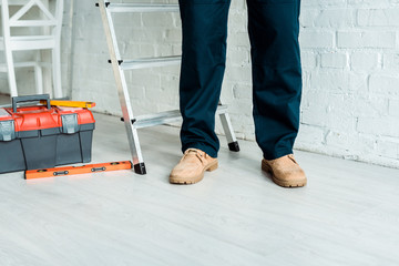 cropped view of installer standing near tool box