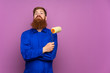 © luismolinero - Painter man with long beard over isolated purple background