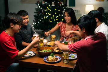 Wall Mural - Group of Asian people have a dinner party and beer at home.