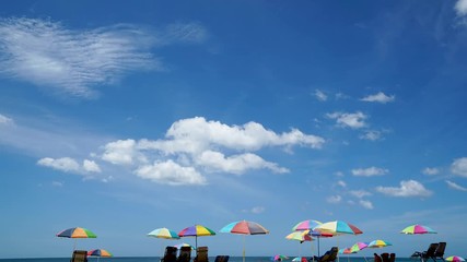 Wall Mural - time lapse A holiday with Blue sky and deep blue sea with a various color of beach umbrella ,4k