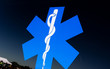 canvas print picture - Blue star with Rod of Asclepius as symbol of medicine, health careand pharmacy. Sign on dirty and dusty window that is reflecting sky.