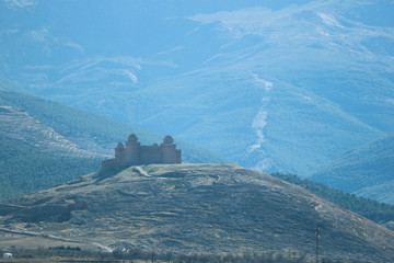 panoramic view of medieval castle la Calahorra with the Sierra Nevada mountains on the background