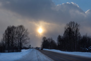 Wall Mural - Russia. South Of Western Siberia. Picturesque cold sunset on a snow-covered road in The mountain Shoria.