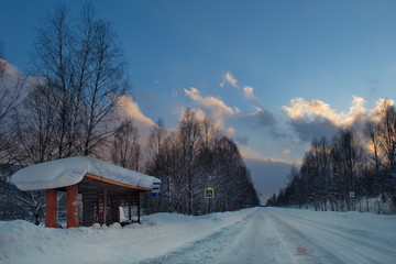 Wall Mural - Russia. South Of Western Siberia. Picturesque cold sunset on a snow-covered road in The mountain Shoria.