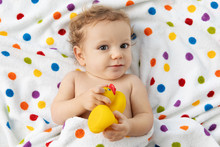 Cute Baby Wrapped In Towel After Bath Holding Rubber Duck
