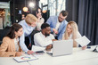 © gorynvd - Multiethnic group young business colleagues having meeting about their business project and comparing data from different reports and table laptop.