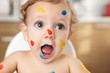 © Lisa Tichané - Close up portrait of funny baby with finger paint on face