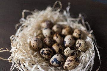 Eggs stacked in a pile or pyramid in a nest on a wooden background . for the Easter holiday . Easter background . new color and light for Easter photos and pictures