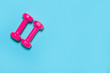 © Augustas Cetkauskas - Pink dumbbells isolated on blue background