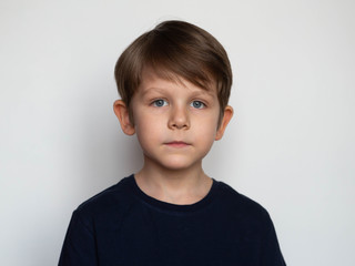 portrait of a serious little boy on a white background