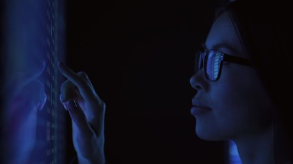 Wall Mural - The woman working on sensor display in the dark laboratory