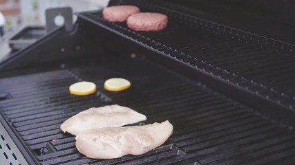 Sticker - Grilling an Atlantic salmon, chicken breast, vegetable skewers, and vegetarian burgers on an outdoor grill.