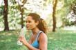 Fit black woman drinking water after break workout at park,Positive thinking,Relaxation time
