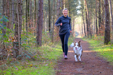 Happy Woman Full Of Vitality Exercising Her Dog