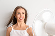 © Pixel-Shot - Young woman with electric fan on white background
