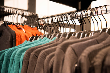 clothes hang on hangers, sold in the store.