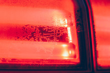 Frost On The Car. Details Of The Car. Getting The Sun And Frost. Early Spring Sunrise Morning.Rear Lights Of The Machine