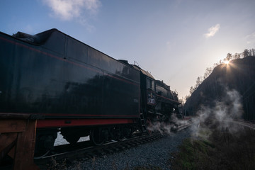 Wall Mural - Angasolka, Russia - october 17, 2019 - Steam engine smokes while standing at the station