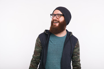 Wall Mural - Portrait if smiling young bearded man looking away