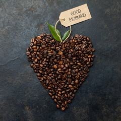 Poster - Coffee beans in shape of heart on dark rustic background