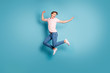 © deagreez - Portrait of funny enthusiastic guy enjoy spring vacation feel crazy emotion scream jump wear good-looking outfit sneakers isolated over blue color background