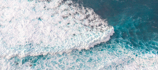 Wall Mural - aerial view to waves in ocean splashing waves.