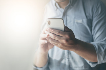 Wall Mural - using cell phone.hand holding texting message on screen mobile chatting friend ,search internet information sitting on sofa in office.technology device contact communication connecting people concept