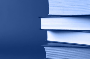 A stack of books on a classic blue background.