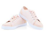 Fototapeta Las - women's pink canvas canvas comfortable shoes on a white background sneakers