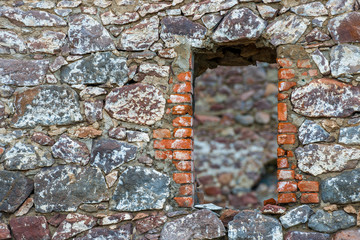 Ancient castle wall with niche window close up