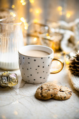 Wall Mural - Cozy winter holiday decoration, Christmas lights and coffee cup with decor details, real home