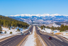 View On Highway With Rocky Mountains In The Background In Winter