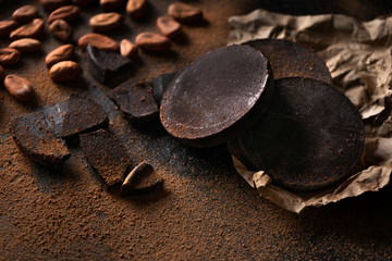 Canvas Print - Cacao beans and chocolate on dark background