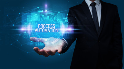 Man hand holding PROCESS AUTOMATION inscription, technology concept