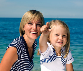 mother with daughter at sea cost together, happy real family smiling looking to horizont, lifestyle people concept, on vacations close up