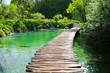 Wooden footbridge built above the blue waters of the Plitvice Lakes National Park in Croatia