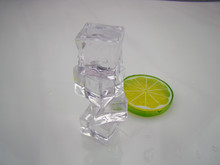 Four Piece Of Ice.White Background In Front Of A Pile Of Ice And Yellow Green Lemon Slices