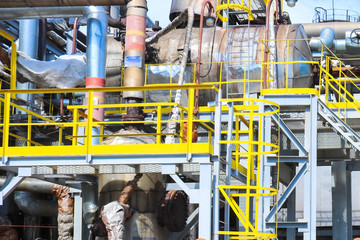 Wall Mural - Iron metal industrial plant installations with stairs, fences and pipes, distillation columns at the oil refining chemical metallurgical construction plant