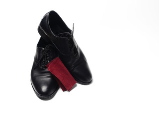 A pair of men's shoes made of genuine leather and velour fabric for Shoe care, isolate on a white background