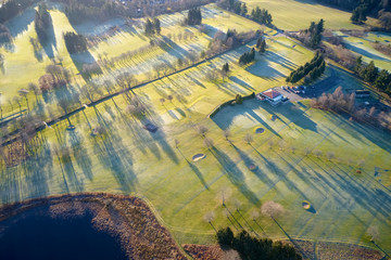 Aerial view of golf course green and clubhouse from above frozen grass in winter at Aboyne Aberdeenshire Scotland