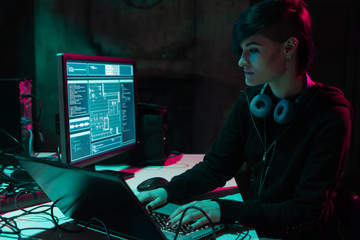 Wanted hackers coding virus ransomware using laptops and computers in the basement. Cyber attack, system breaking and malware.