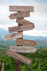 Blank wooden road sign at trekking wayside on the mountains