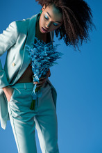 Attractive African American Woman Holding Bouquet Isolated On Blue