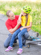 © Ermolaev Alexandr - Father looks at the wound of his daughter, who fell from a bicycle