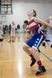 © Crystal Madsen - Young girl playing basketball on indoor court